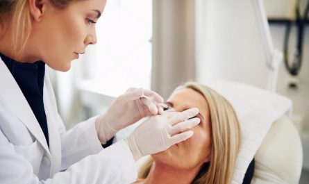 Dermatologist performing a close-up skin examination on a female patient in a UAE clinic